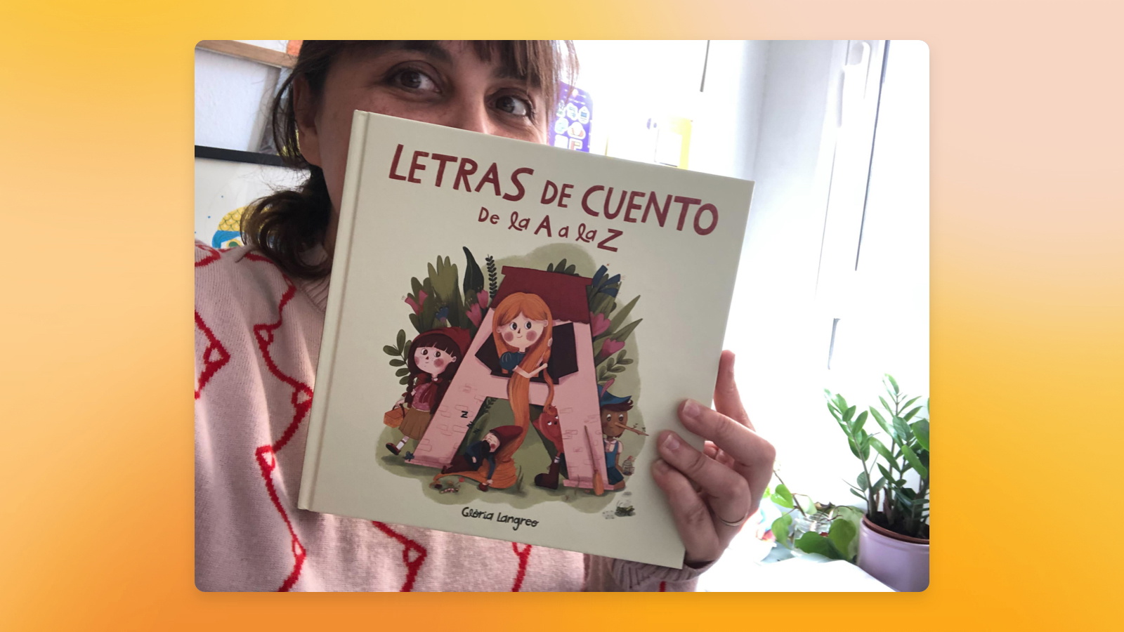 Image showing Glòria Langreo holding the children’s book she illustrated.